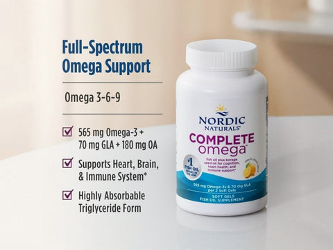 Nordic Naturals Complete Omega fish oil supplement bottle on a light surface with text callouts on the left detailing its full-spectrum omega support and key ingredients.