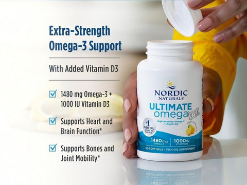 Nordic Naturals Ultimate Omega-3 soft gels bottle being held by a person, with text on the left describing extra-strength omega-3 support and added vitamin D3.