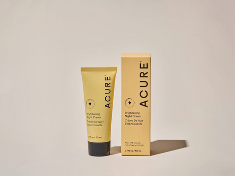 Acure Brightening Night Cream tube and box on a beige background