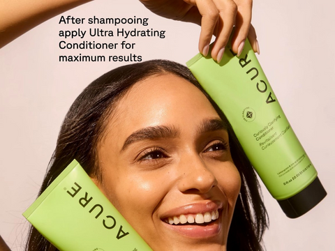 Woman holding two bottles of ACURE Ultra Hydrating Conditioner with text on a beige background