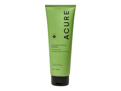 Green shampoo bottle with 'Acure' branding on a white background