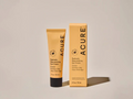 Acure Radically Rejuvenating Eye Cream tube and packaging on a beige background