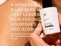 Sun Serum Drops bottle held against skin with product description text overlay