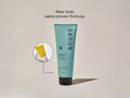 Acure lotion bottle with a smaller yellow bottle in the corner on a beige background