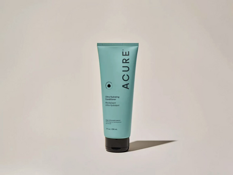 Acure lotion tube on a beige background
