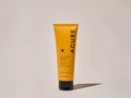 Acure skincare tube on a beige background