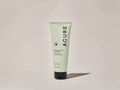Acure hair product tube on a light beige background