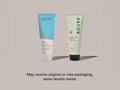 Two Acure shampoo bottles, one blue and one green, on a beige background.