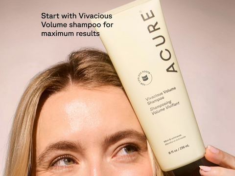 Person holding a bottle of Acure Vivacious Volume shampoo with text on a neutral background