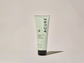 Acure shampoo tube on a beige background