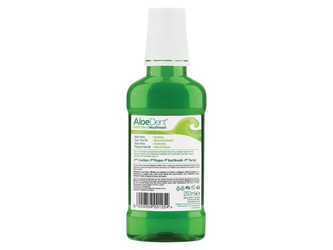 Green bottle of AloeDent mouthwash on a white background