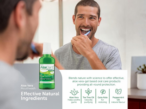 Man brushing his teeth with Aloe Dent mouthwash displayed.
