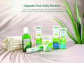 Aloe Dent dental care products including toothpaste, mouthwash, and toothbrush on a neutral background with greenery.