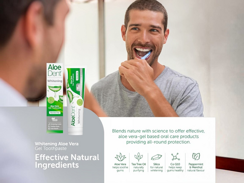 Man brushing his teeth with Aloe Dent toothpaste and products displayed.