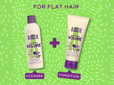 Aussie Volume shampoo and conditioner on a green background with text indicating use for flat hair.