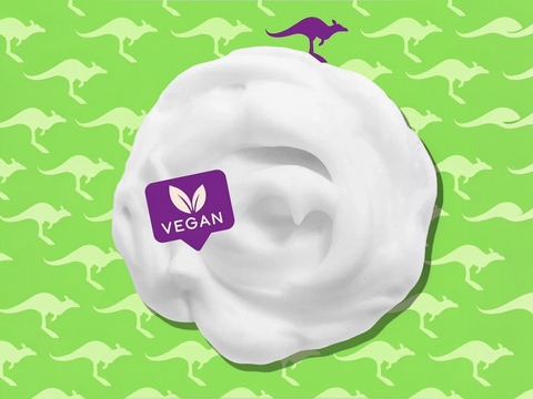 White cream with a vegan label on a green background with kangaroo patterns