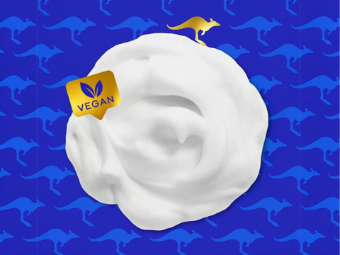 White cream with a vegan label on a blue background with kangaroo pattern