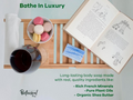 Bathe In Luxury soap advertisement with a cup, book, and macarons on a tray.