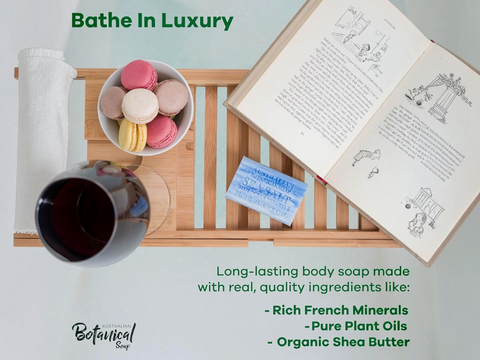 Bathe In Luxury soap advertisement with a cup, book, and macarons on a tray.