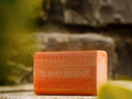 Bar of Australian Botanical Soap with Vitamin C on a wooden surface with a natural background