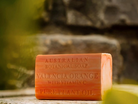 Bar of Australian Botanical Soap with Vitamin C on a wooden surface with a natural background