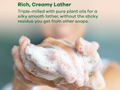 Hand with soapy foam and text about rich, creamy lather and plant oils.