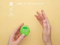 Close-up of BIOMED green and white floss stretched between fingers.