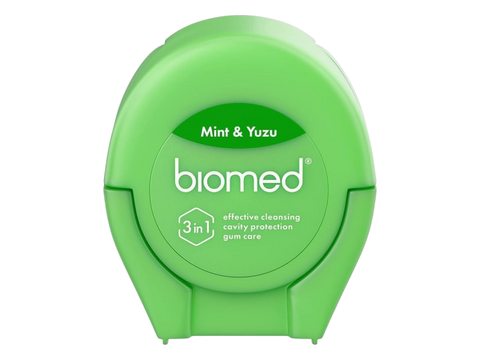 BIOMED Mint and Yuzu flavored dental floss dispenser on a clean background.