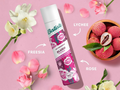 Batiste dry shampoo can with lychees and flowers on a pink background