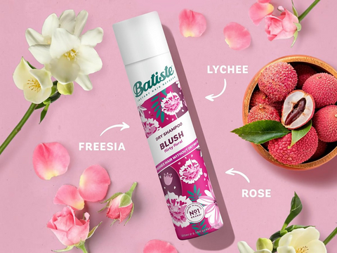 Batiste dry shampoo can with lychees and flowers on a pink background