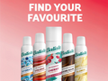 Batiste dry shampoo bottles with flavor labels on a pink background