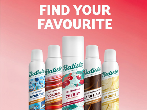 Batiste dry shampoo bottles with flavor labels on a pink background