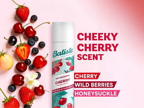 Batiste dry shampoo bottle with cherry and berry ingredients on a pink background