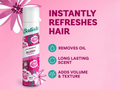 Batiste dry shampoo bottle with pink floral design on a pink background