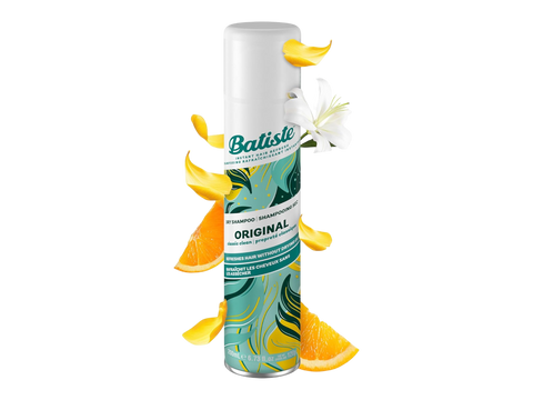 Batiste Original hair spray bottle with orange slices and flowers on a white background