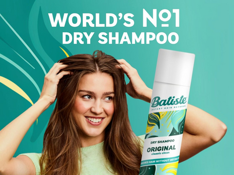 Woman using Batiste dry shampoo with product displayed on a teal background