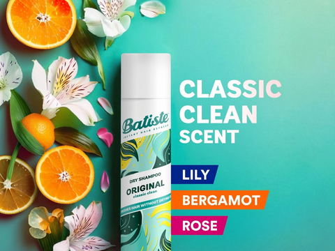 Batiste dry shampoo can with oranges and flowers on a teal background
