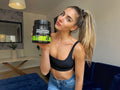 Woman holding a supplement container in a living room setting