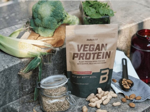 Bag of vegan protein powder with vegetables and nuts on a stone surface