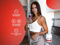 Woman holding a glass of purple drink with nutritional information on a red background