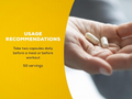 Hand holding two capsules with usage recommendations text on a yellow background
