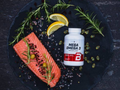 Mega Omega 3 supplement bottle on a plate with salmon and lemon
