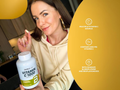 Woman holding a bottle of Biotech USA Vitamin C 1000 with product details on a yellow background.
