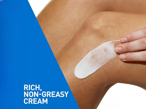Person applying a white cream patch on their skin with a blue and white background.