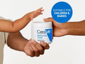 CeraVe moisturizing cream being passed from an adult to a child's hand on a white background