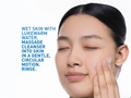 Woman applying cleanser to her face with text on a white background
