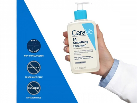 CeraVe SA Smoothing Cleanser bottle held by a hand with a blue and white background