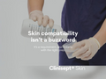 Person wearing gloves holding a bottle with text about skin compatibility and Clinisept+ Skin.