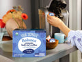 How to Use: A Four Sigmatic coffee pod being inserted into a Keurig brewer.