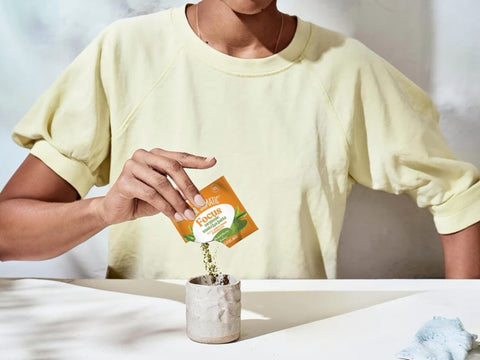 How to Use: Four Sigmatic Matcha Latte packet being mixed in a mug.